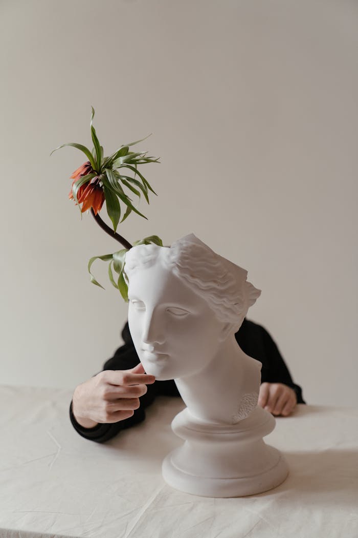Creative blend of classical sculpture with vibrant bloom conceptual art.